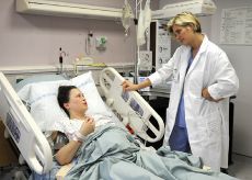 US Navy midwife checks on a mom.jpg